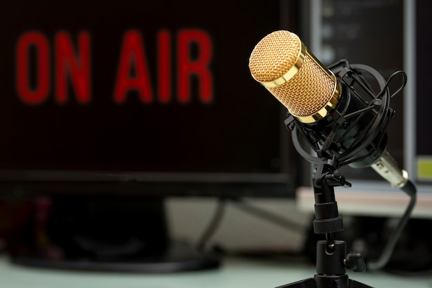 Professional microphone on work table for podcast broadcasting or radio speech