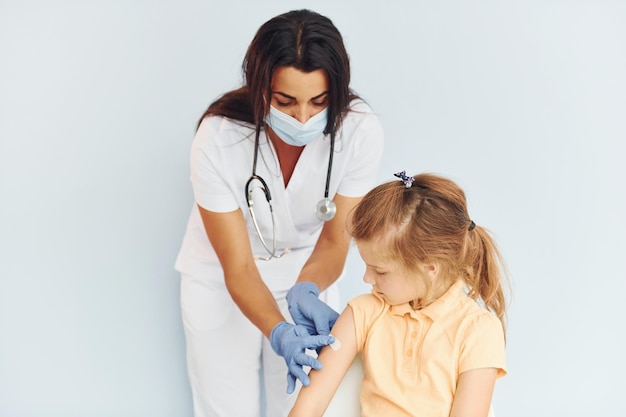 Professional occupation Doctor in uniform making vaccination to the patient