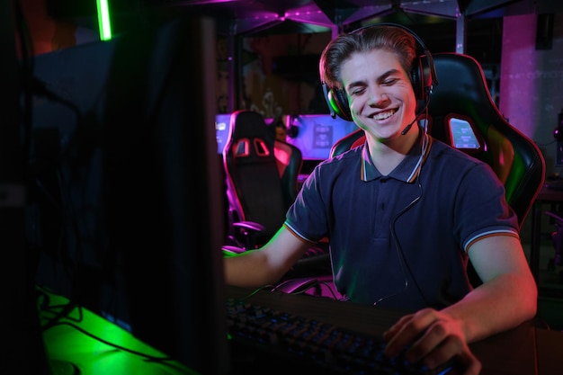 Professional photo of young male caucasian cyber sportsman in gaming club training for important match.