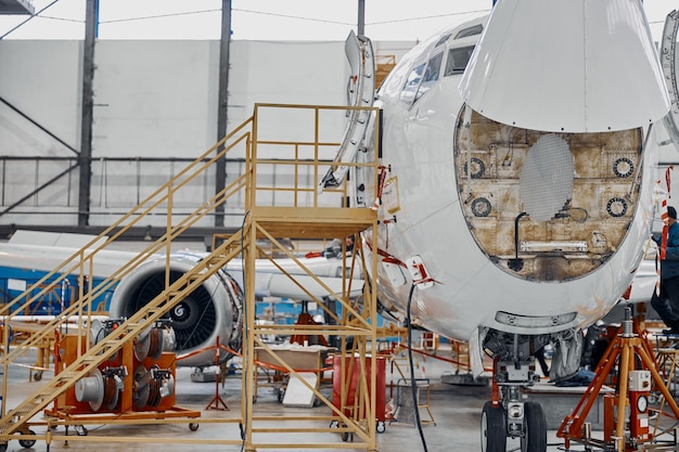 Professional plane expluatation service in big hangar