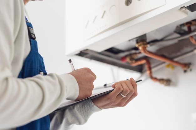 Photo professional plumber doing a boiler check