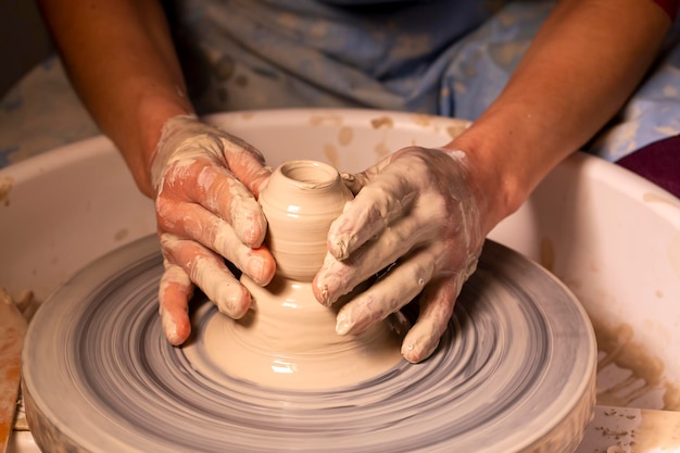 Professional potter making bowl in pottery workshop