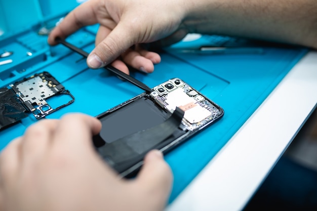 Professional smart phone repair shop or service. Close up shot. Electronics concept.