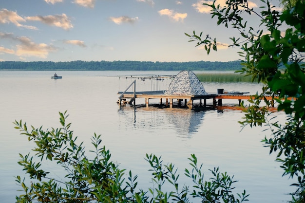 Professional spinning fishing in the morning on the lake at sunset