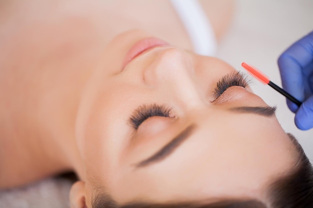 Professional stylist lengthening female lashes