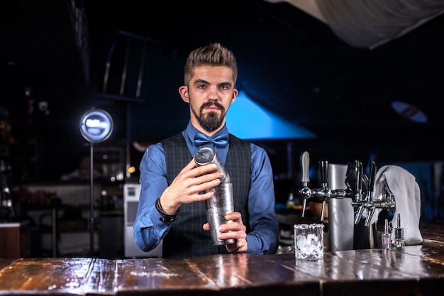 Professional tapster is pouring a drink at the nightclub