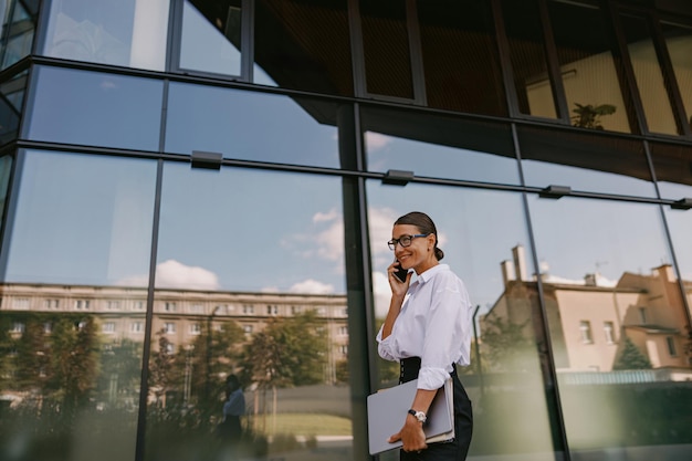 A Professional Woman Dressed in Business Attire Sitting Confidently with Her Laptop