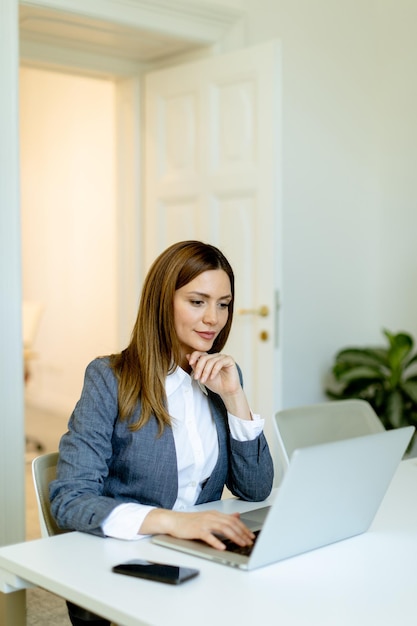 Professional woman engaging in business activities at a modern office space during work hours