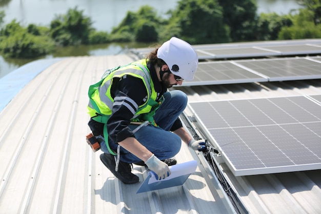 Professional worker installing solar panels on the roof of a house