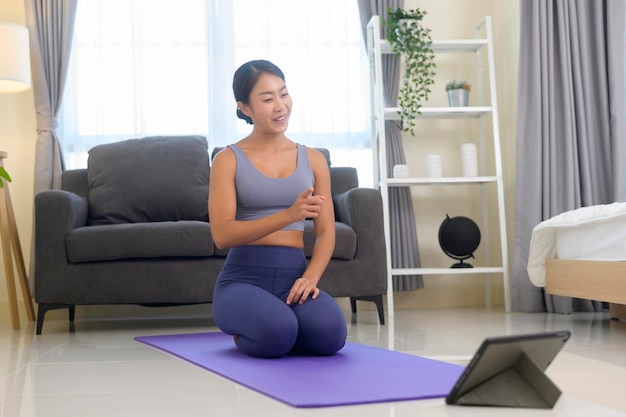 A Professional yoga coach teaching online training class to students during live streaming