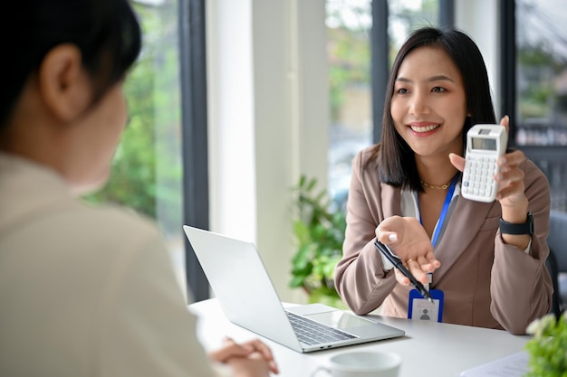 ProfessionalAsian female banker or financial consultant discussing with a female client