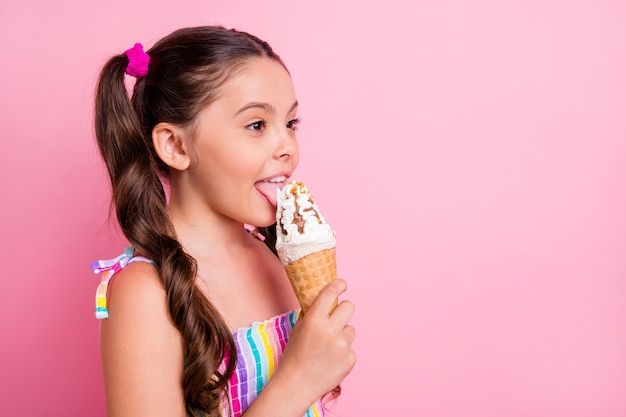 Photo profile beautiful little lady hold big cone ice cream lick tongue