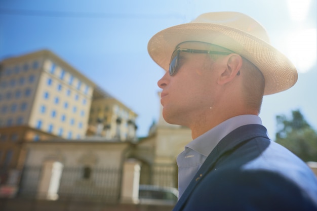 profile male portrait with hat on the street