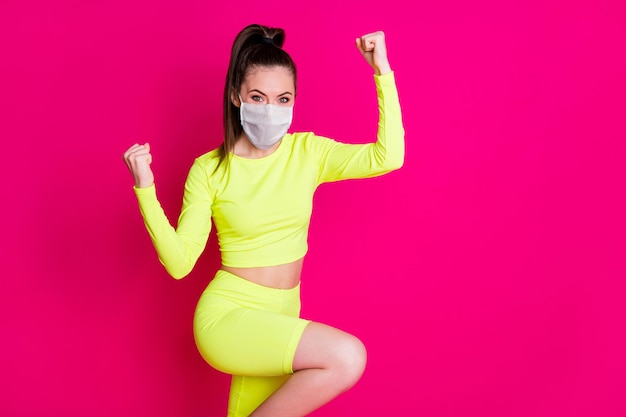 Profile photo of astonished lady stand fists up dress respiratory sport suit isolated on vibrant shine pink color background