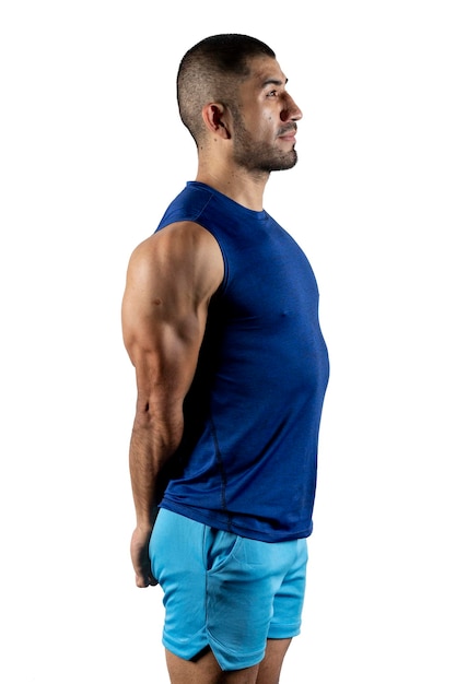 Profile portrait of a man in sportswear stretching his arms against a white background