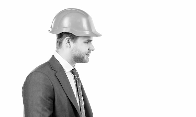 Profile portrait of professional man in hardhat and suit isolated on white engineer