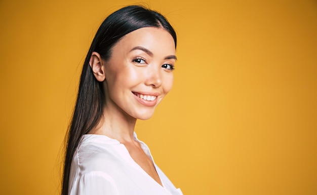 Profile side view photo of attractive smiling business woman isolated on yellow background