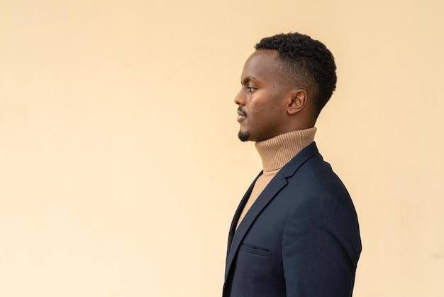 Profile view portrait of young handsome black businessman