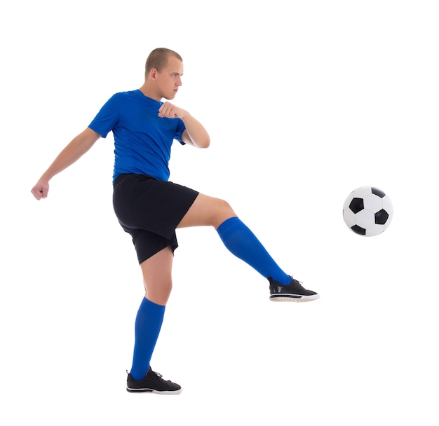 Profile view of soccer player in blue uniform kicking ball isolated on white background