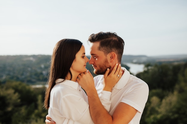 Profiles of romantic couple looking at each other  of beautiful landscape.