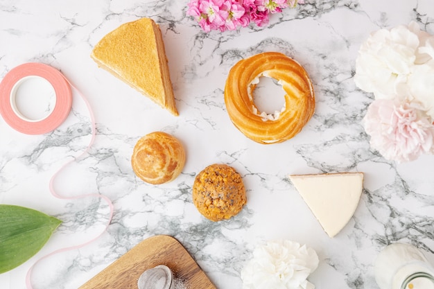 Profiteroles with custard, Piece of delicious cake on the marble table.Sweet dessers top view flat lay. Space for text