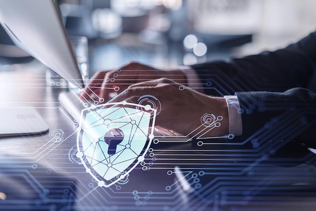 A programmer is typing a code on computer to protect a cyber security from hacker attacks and save clients confidential data Padlock Hologram icons over the typing hands Formal wear