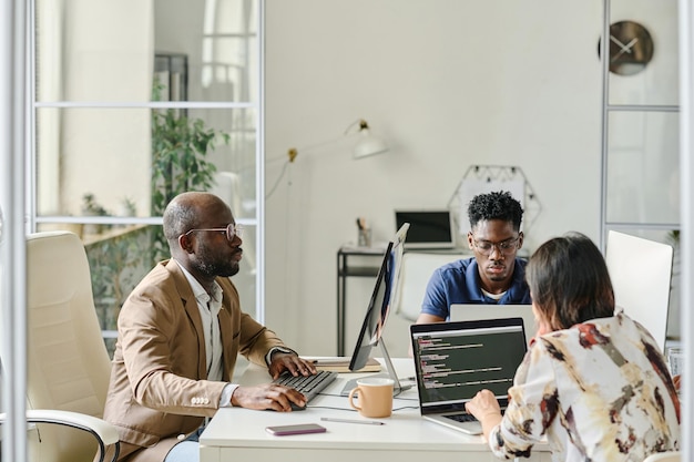 Programmers working in team on computers