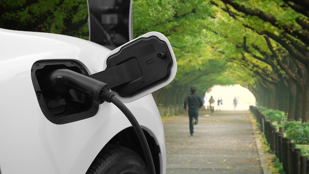 Progressive EV car recharging battery at the park surround with people and tree