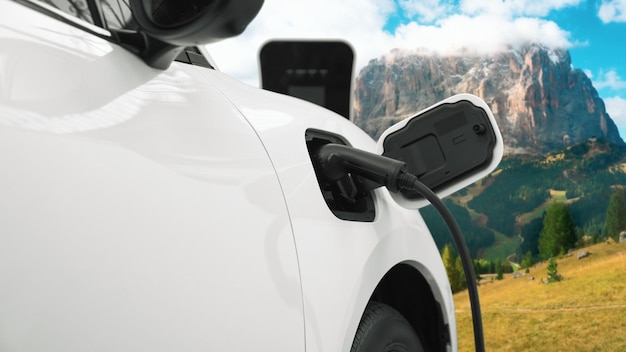 Progressive travel concept by EV car in remote mountain with charging station