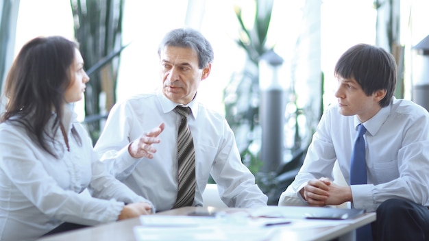 Project leader talking to business team in the workplace