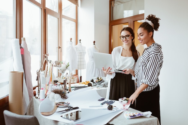 Project manager consultates young designer two women in design studio