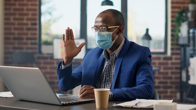 Project manager using remote videocall conference on laptop during covid 19 pandemic. Meeting with colleagues on online videoconference call for internet telecommunication telework.