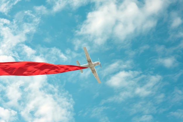 Promotion Airplane with banner horizontal a red banner Sky background with empty space for text for