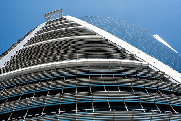 Prospective view to new modern building Modern office building with glass facade on clear sky background