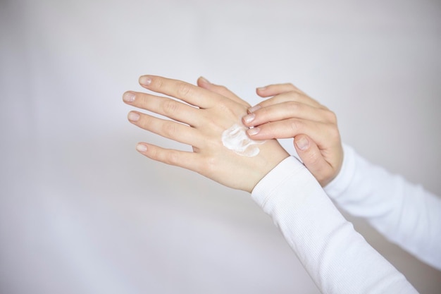 protection of the skin of the hands in the cold season Closeup of a woman applying cream to her