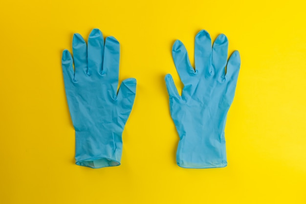 Protective mask and gloves on a yellow background