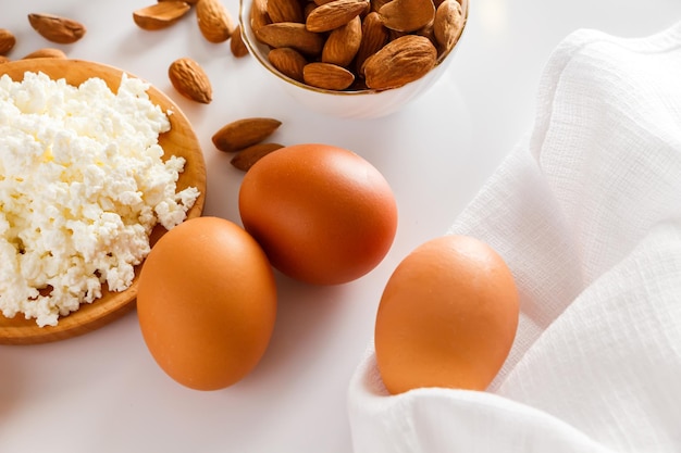 Protein food on a white background  cottage cheese eggs nuts Set of healthy foods for balanced diet