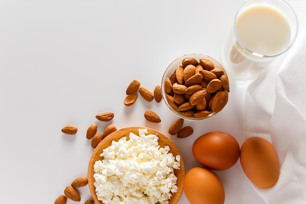 Protein food on white background cottage cheese eggs nuts A set of healthy foods for a balanced diet