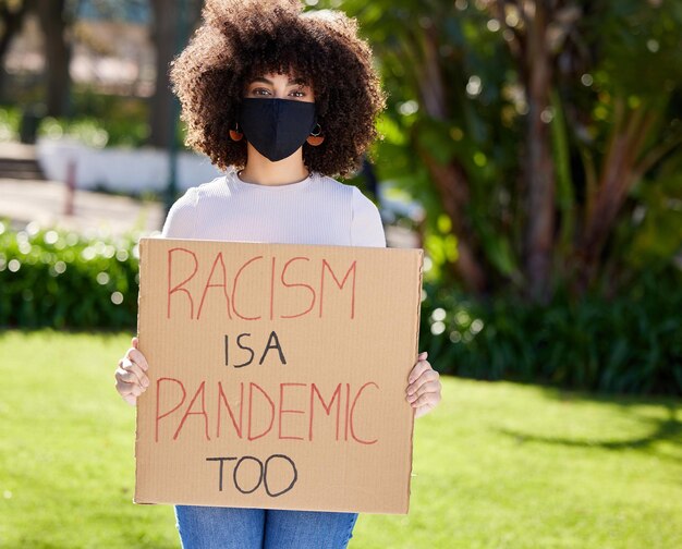 Protesting is our weapon Shot of a unrecognizable woman protesting outside in the park