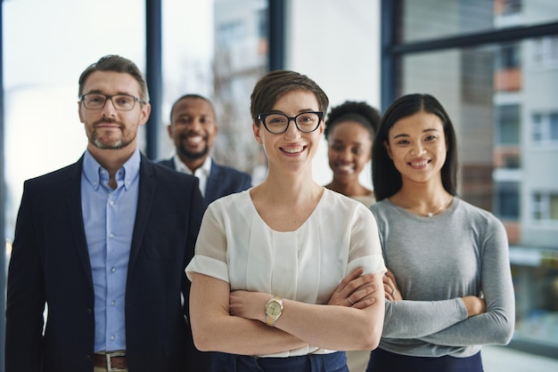 A proud confident and diverse team of lawyers standing in an office or a law firm Portrait of a happy and smiling group of advocates or legal employees in unity teamwork and collaboration