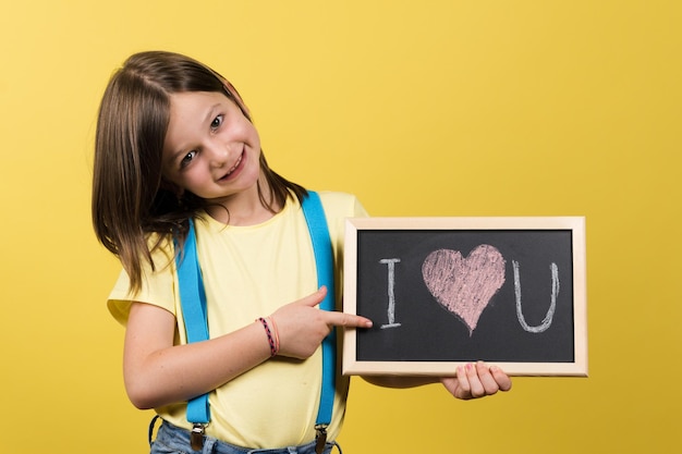 Proud little girl showing love message