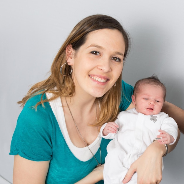 Proud mother Holding Baby Daughter at the house