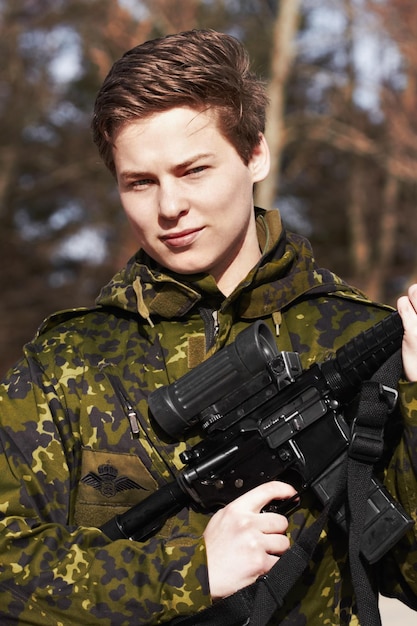 Proudly protecting his country A young soldier standing with a rifle