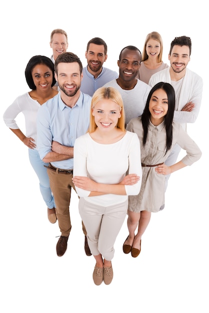 Proudly successful. Top view of positive diverse group of people in smart casual wear looking at camera and smiling while standing close to each other