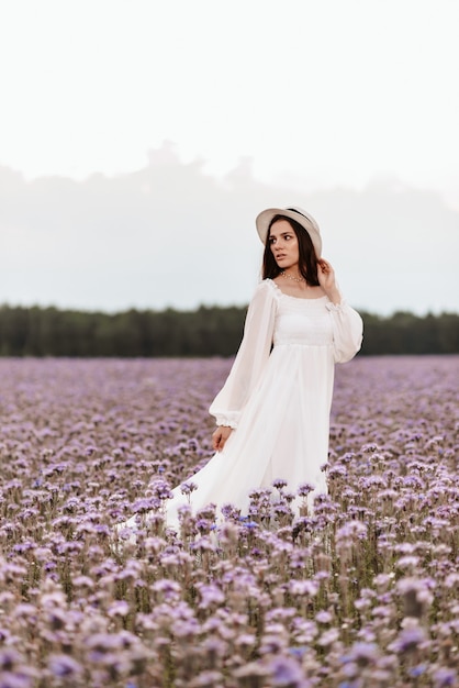 Provence blooming field. The girl enjoys life and gets pleasure