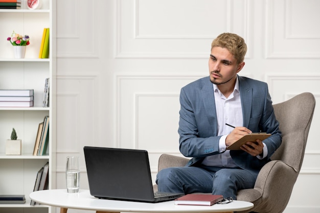 Psychologist conducting online sessions cute handsome young professional man taking down notes