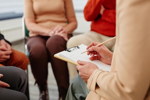 Psychologist making notes during psychotherapy session