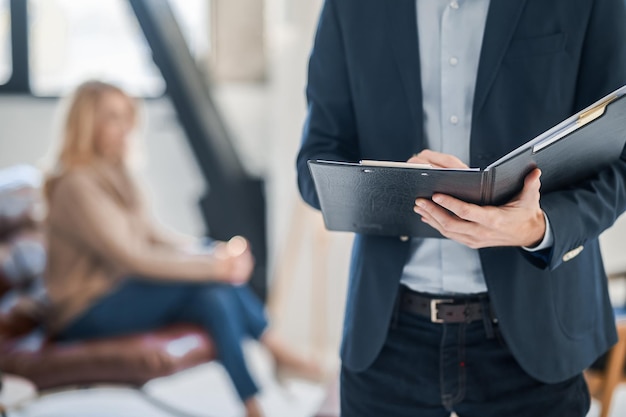 Psychologist taking to a client and making notes