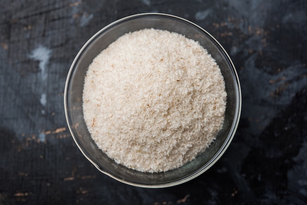 Psyllium husk or isabgol which is fiber derived from the seeds of Plantago ovata, mainly found in India. Served in a bowl over moody background. selective focus