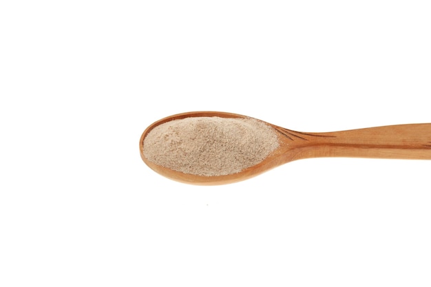 Psyllium Ispaghula Husk in wooden spoon closeup Psyllium coarse flour Dietary Fiber Food Supplement